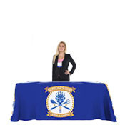 A woman standing near a blue color table